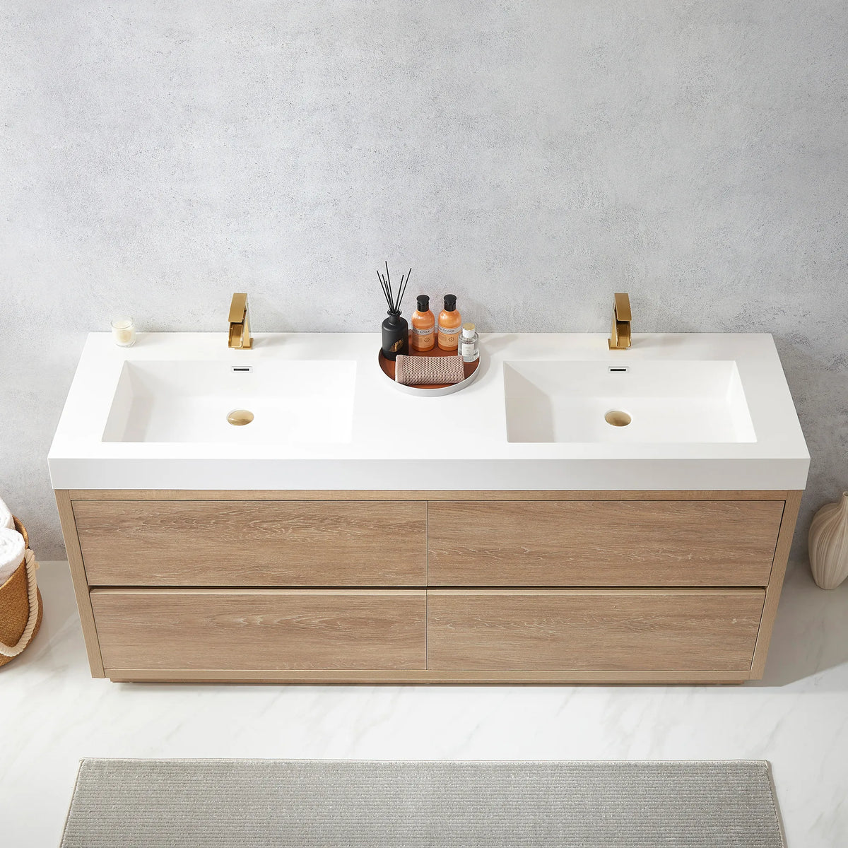 High-angle view of the integrated double sink top with a tray of bottles, gray rug on the floor