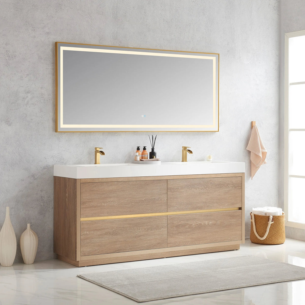 Angled room view of the double vanity with LED mirror, vases at left, towel basket at right
