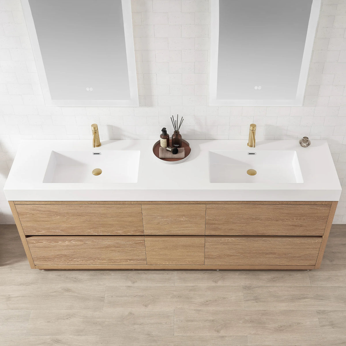 Close view of the double sink top with a bottle tray in the middle, mirrors cropped at top