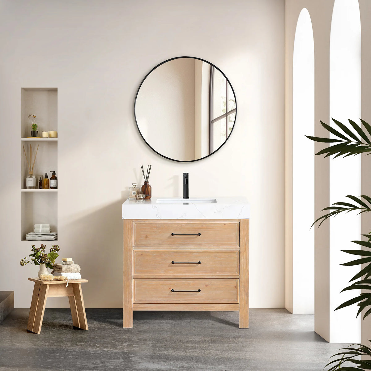 A circular wall mirror above a Fir Wood Brown single vanity of 36 inches, a sunlit bath with an arched wall niche