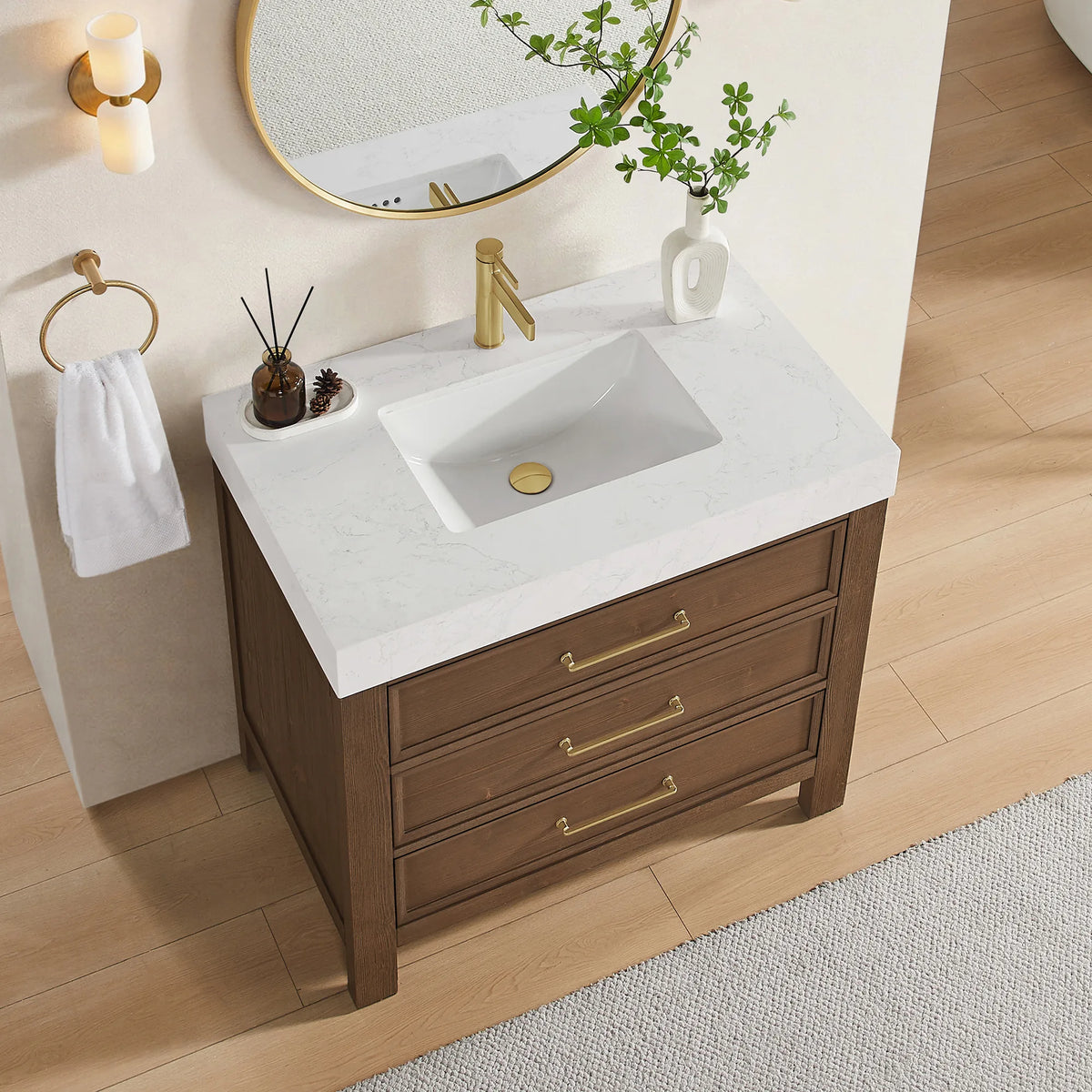 Tighter framing on the Spruce Aged Brown cabinet and its top; a bath with a gold sconce