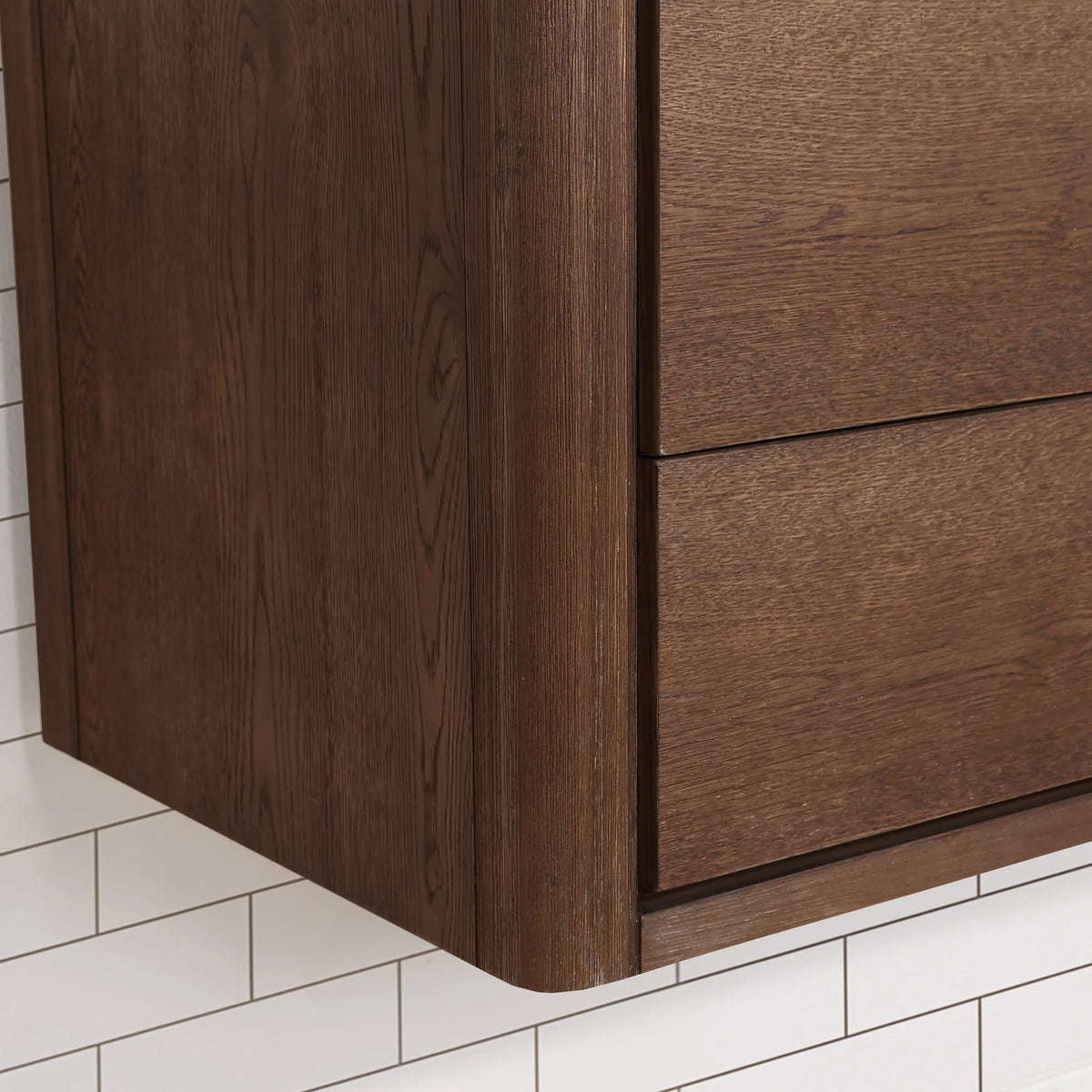 Corner detail on the floating Aged Dark Brown Oak cabinet: soft radius edge and drawer seams, 36-inch model