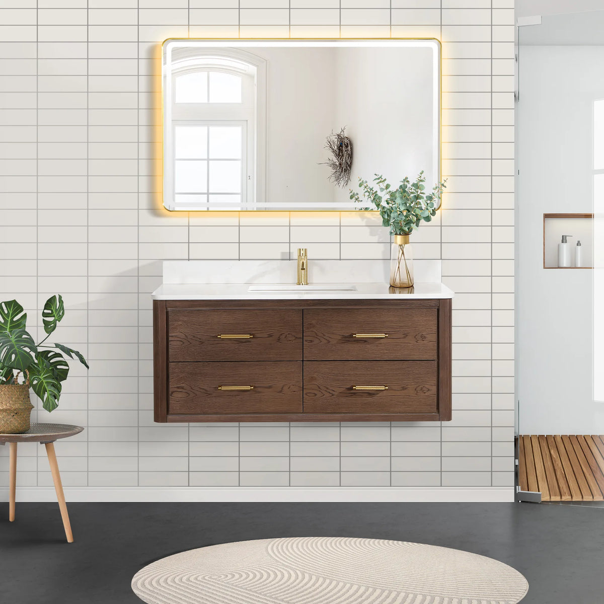 Bathroom scene: floating cabinet in Aged Dark Brown Oak with a lit mirror above and light tile behind, 48-inch model
