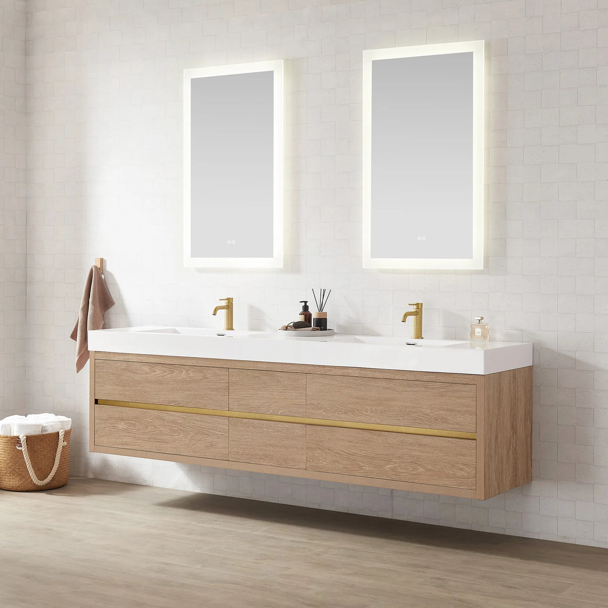 Bright bathroom with an 84 inch floating double sink vanity, rectangular LED mirrors and a towel