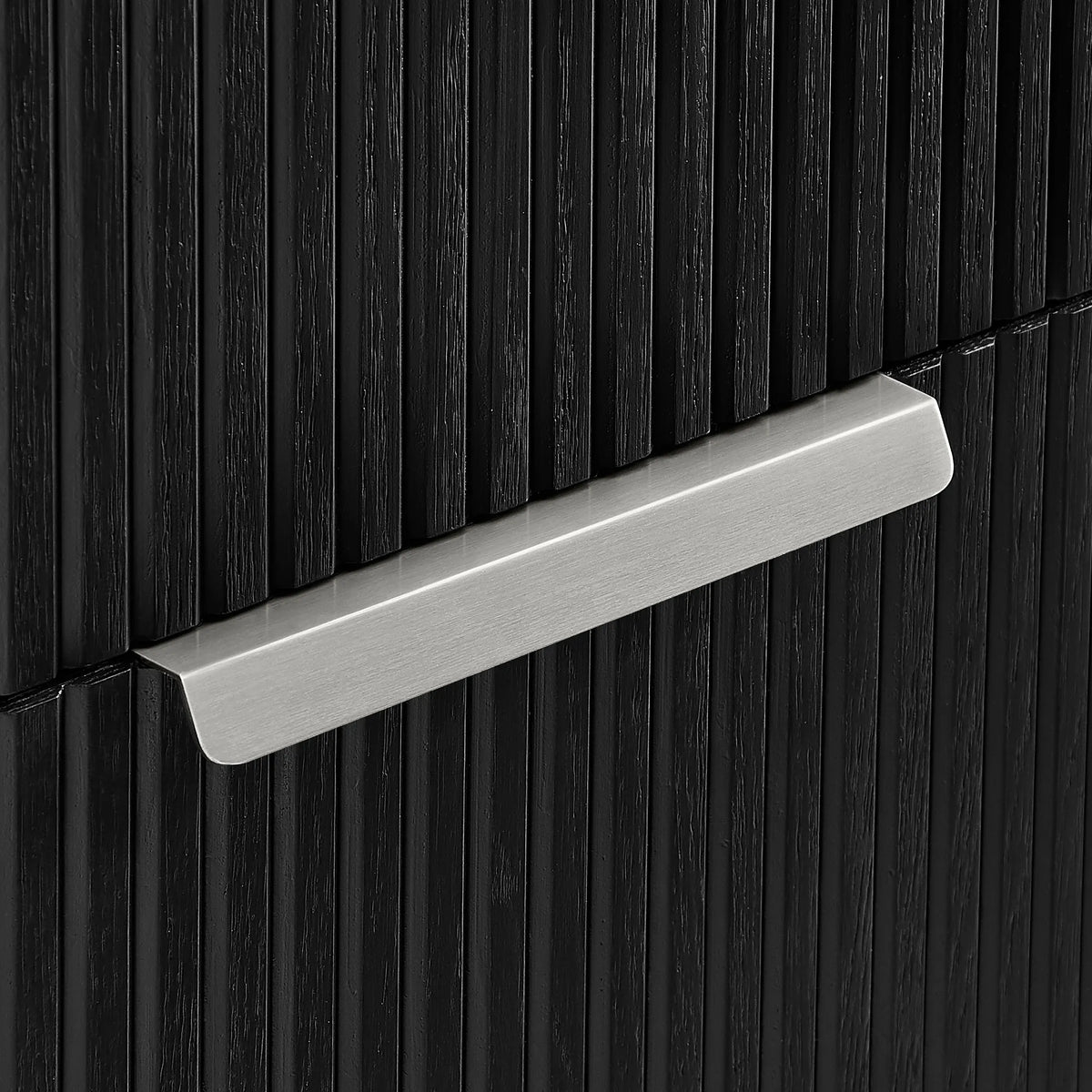 Tight crop of a brushed nickel handle on grooved cabinet panels in Oak Weathered Black, 60 inch double