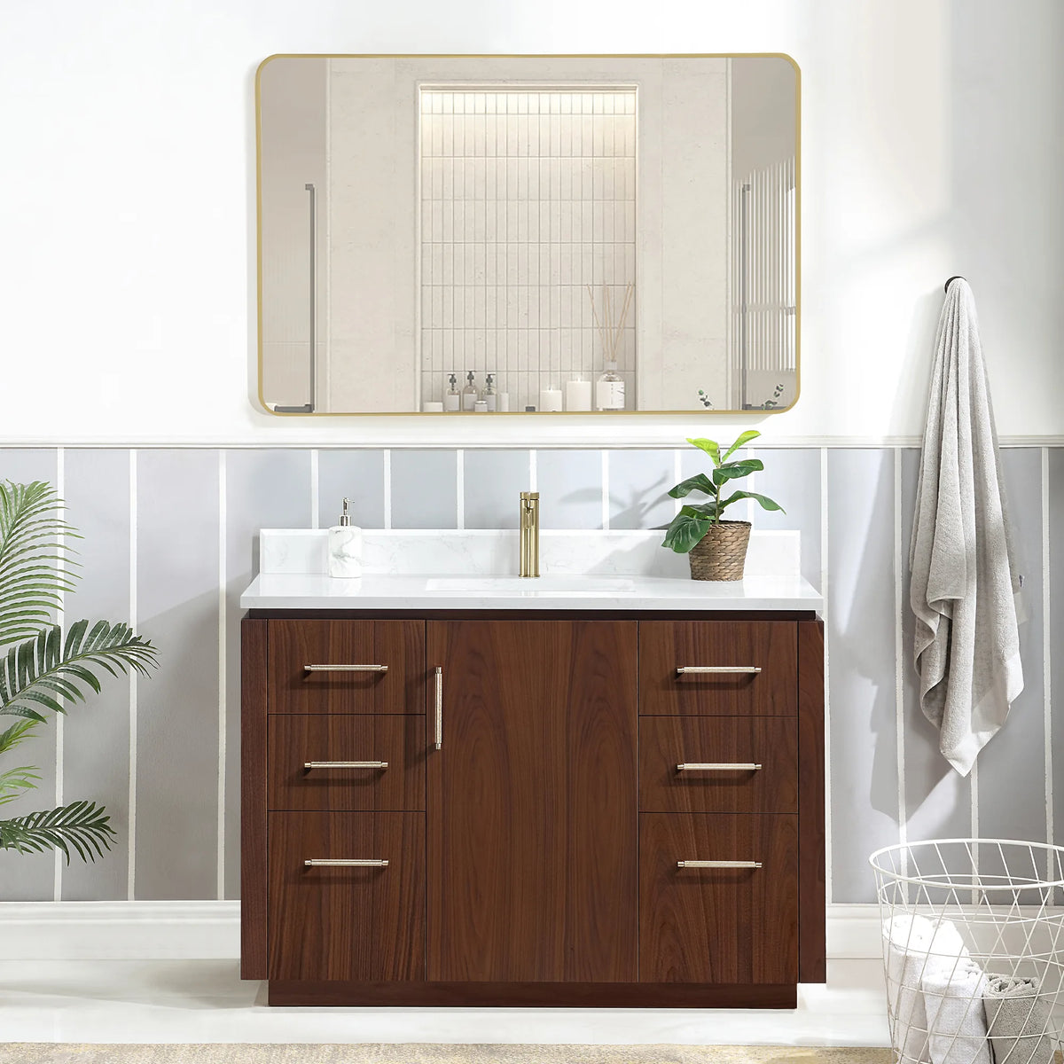 Room scene with a 48 inch vanity, a wide horizontal mirror, a wire basket at the right and a leafy plant at the left