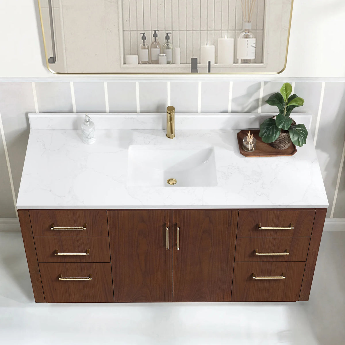 High-angle close view of the undermount ceramic sink on the white grain composite stone top, center doors below