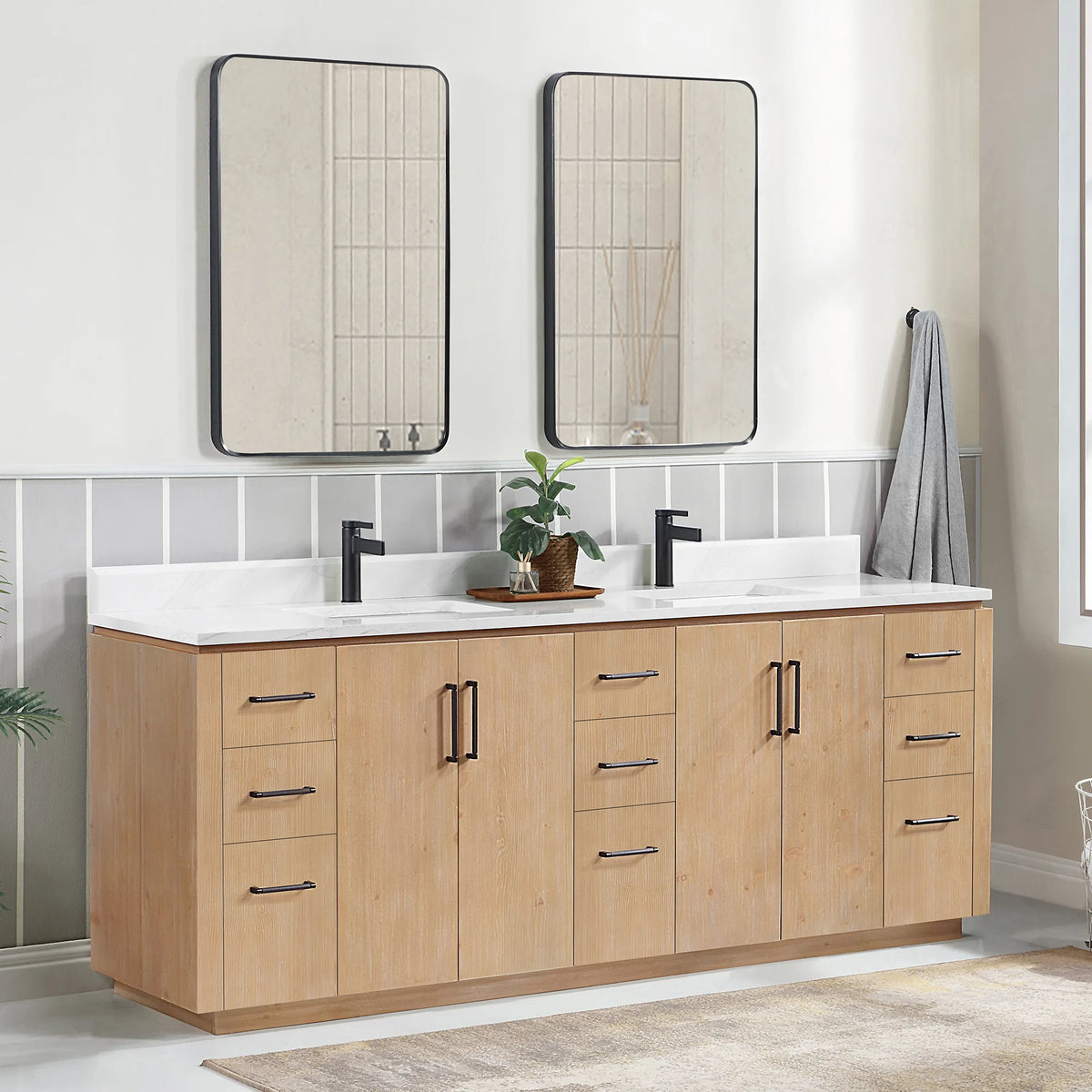 Angled room view of the 84 inch double vanity with mirrors, striped wall, plant and hanging towel