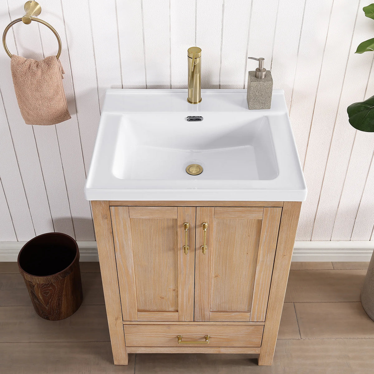Head-on look at the basin top: gold faucet, two doors and a drawer underneath