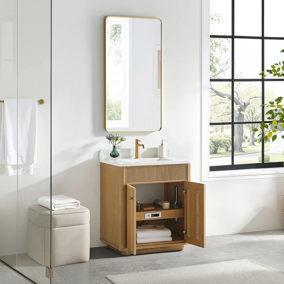 Open storage on the Washed Ash Grey vanity: doors swung back and towels stacked on the shelf