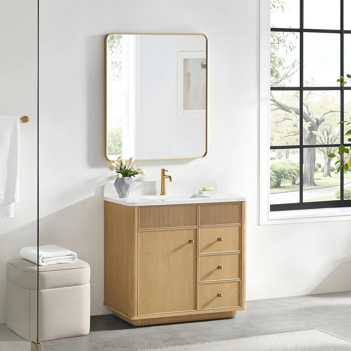 36 inch vanity in Washed Ash Grey with a gold-framed mirror above and a cream stool on a gray floor