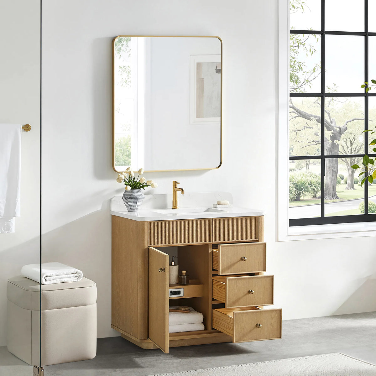 Open storage on the Washed Ash Grey vanity: doors and drawers swung back and towels stacked on the shelf