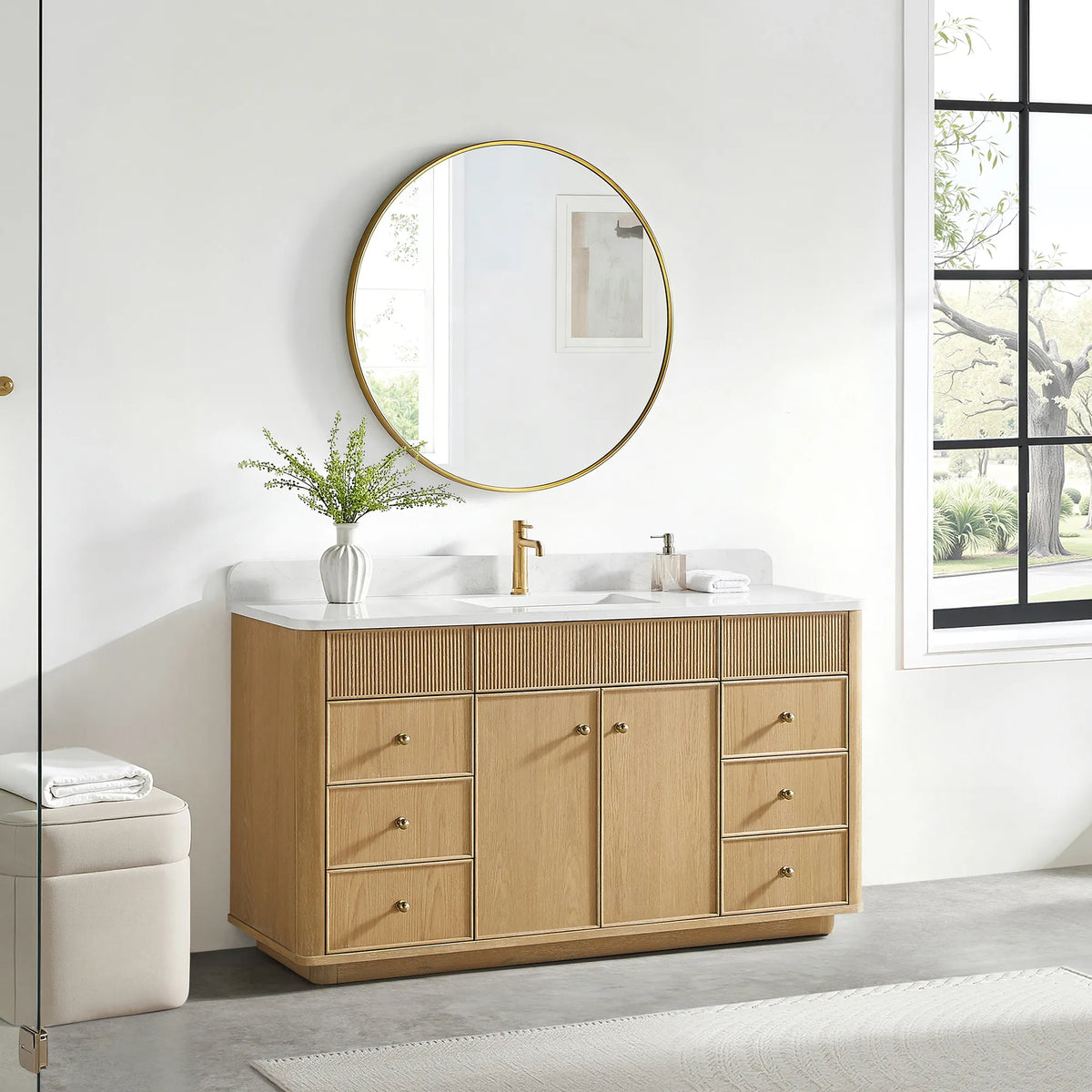 60 inch vanity in Washed Ash Grey with a gold-framed mirror above and a cream stool on a gray floor