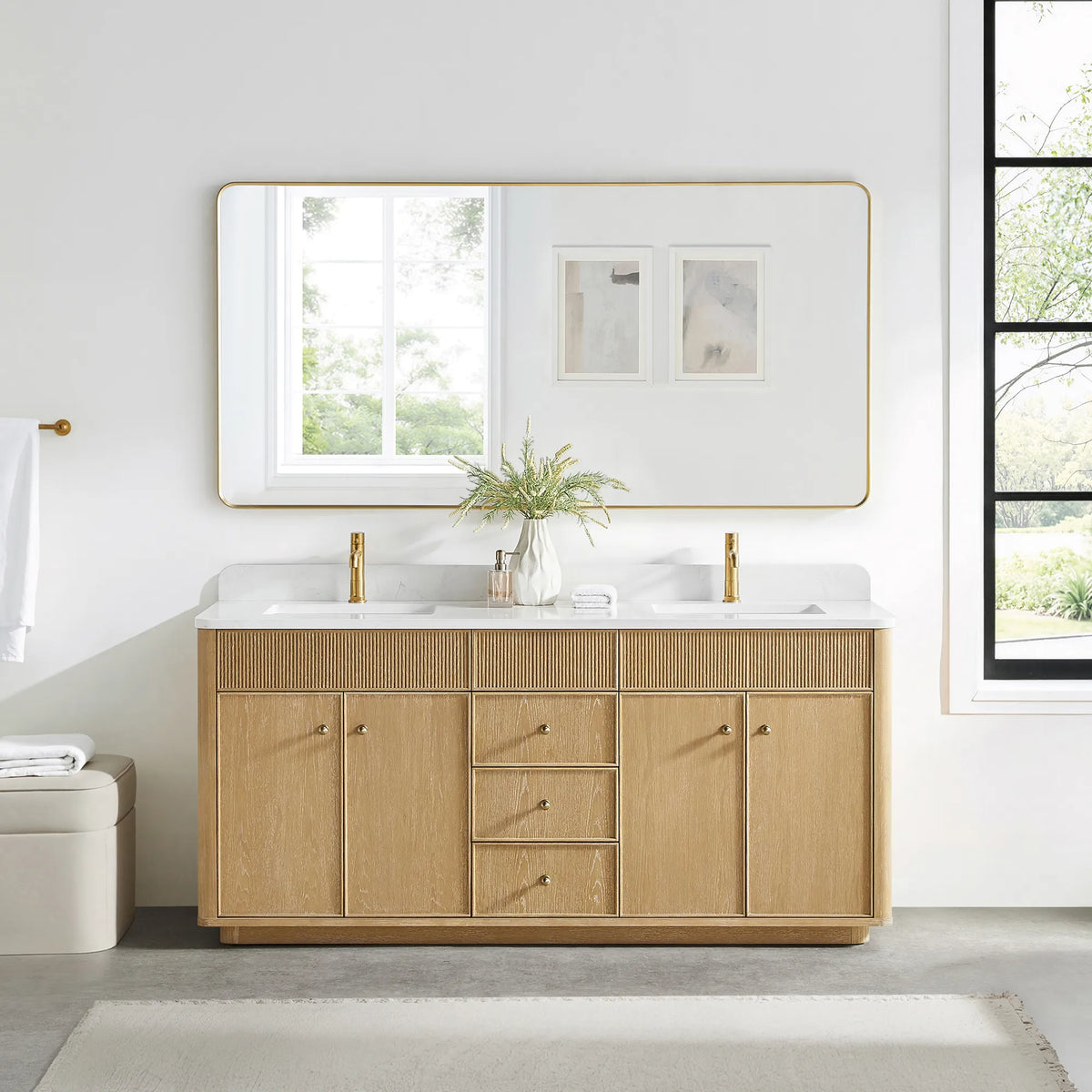 Matching wide rounded-rectangle gold mirror above the Washed Ash Grey vanity in a bathroom with a black-framed window