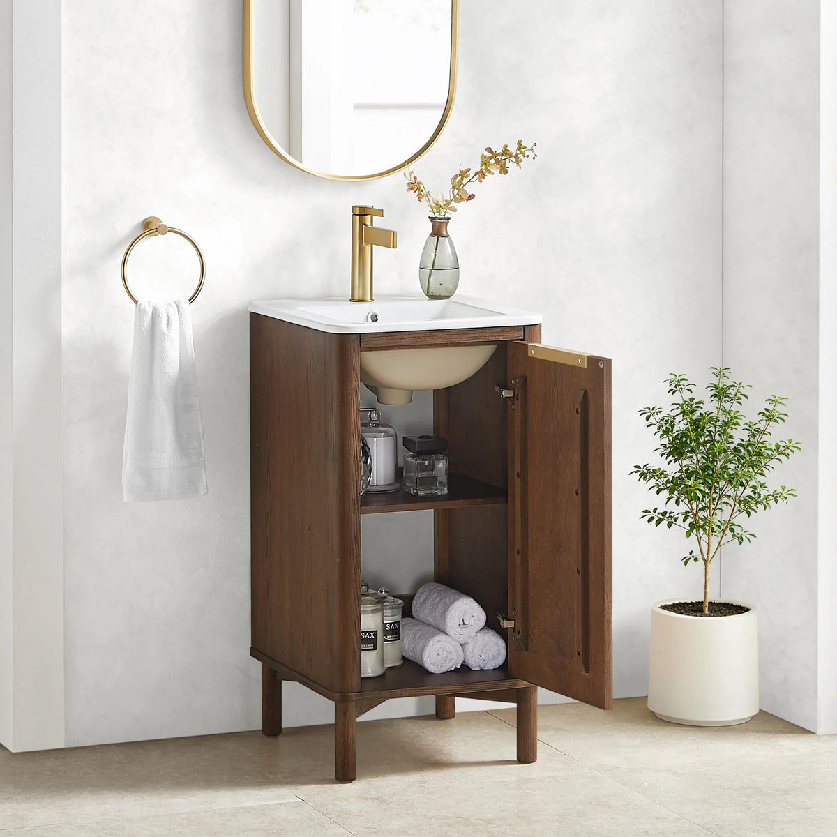 Inside the 18-inch cabinet: a shelf stocked with towels and toiletries, with the basin bowl visible overhead