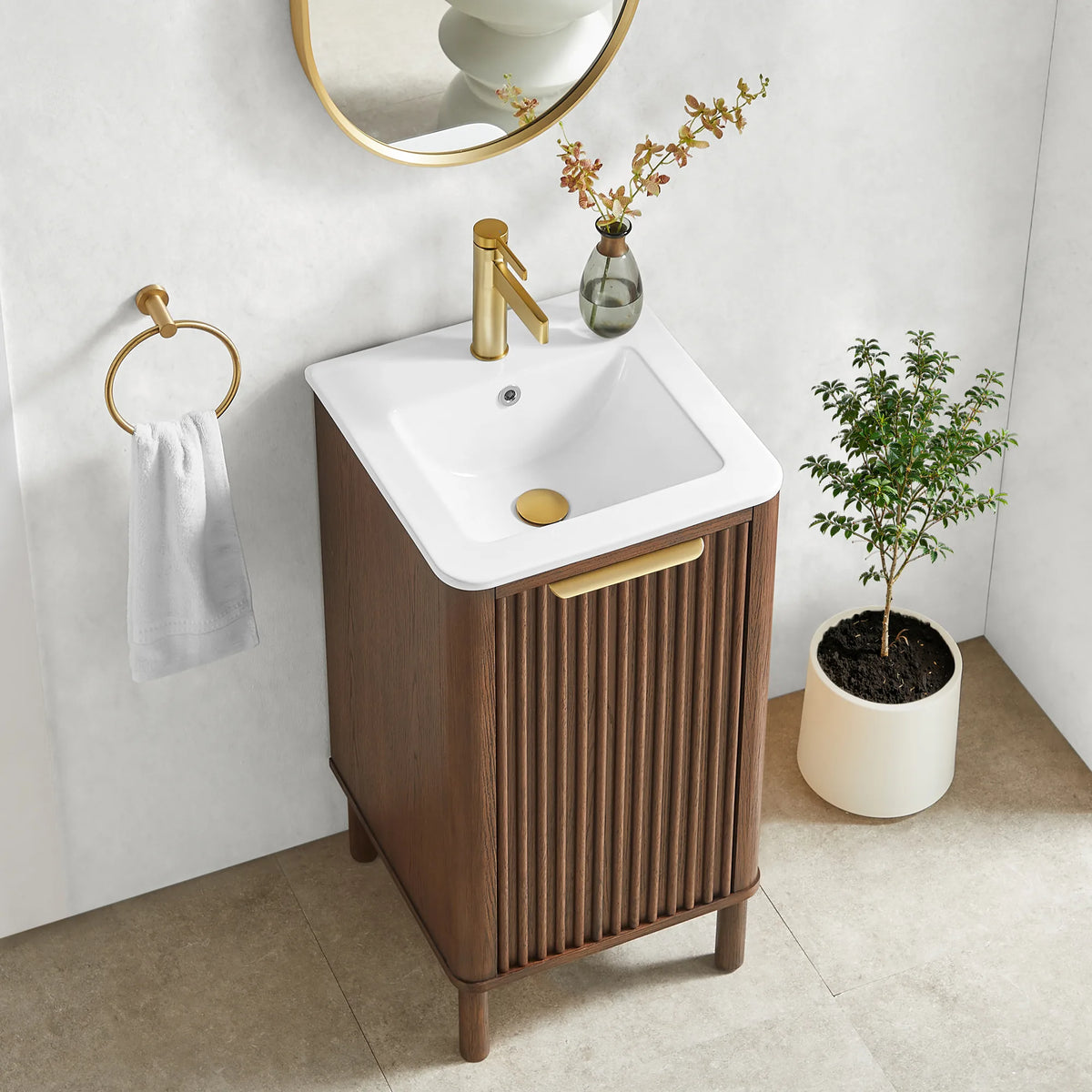High-angle look at the compact 18-inch vanity, its rounded top corner and fluted door with a brushed gold pull