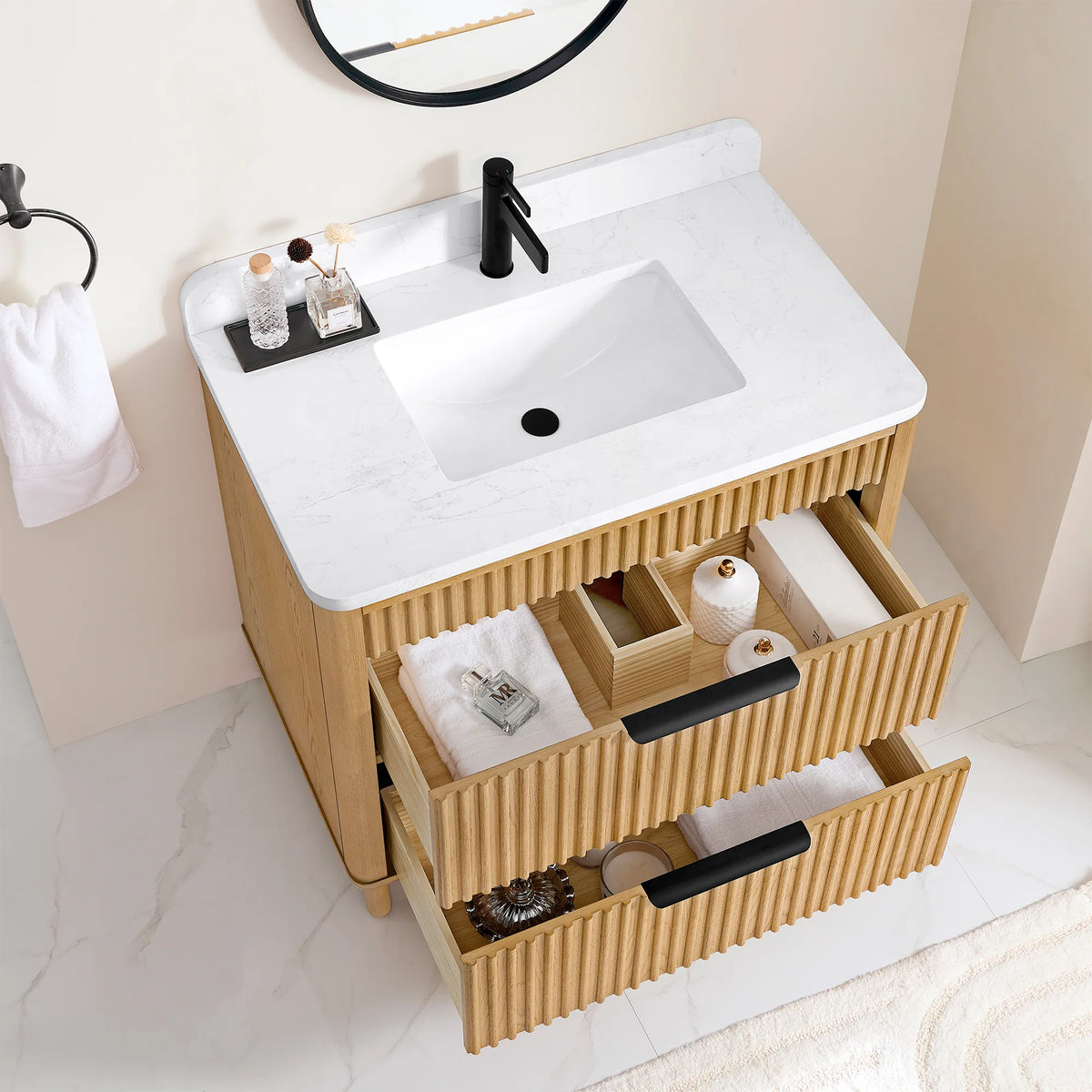 Opened drawers on the 36-inch Oak Weathering Light Brown vanity, a divided tray and folded linens in view