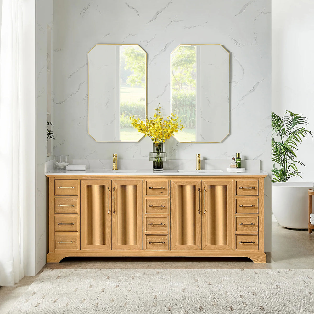 Room view: two octagonal mirrors over an 84 inch double vanity in Oak Natural Brown, marble-look walls and tall windows