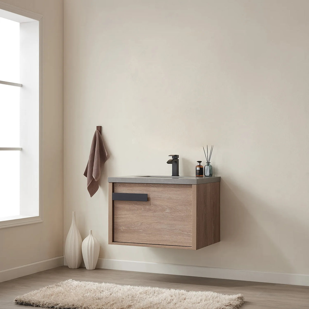 Wide room shot from the side, window and wall hook with a towel beside the cabinet
