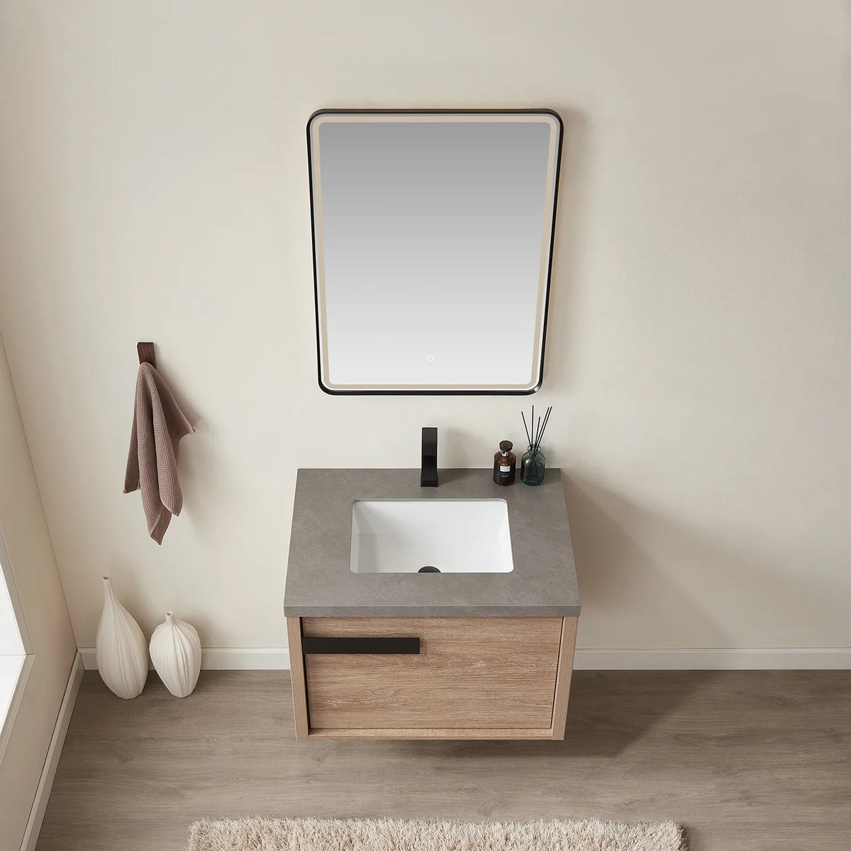 Straight-on high-angle view: mirror above, basin centered on the stone top, oak drawer below