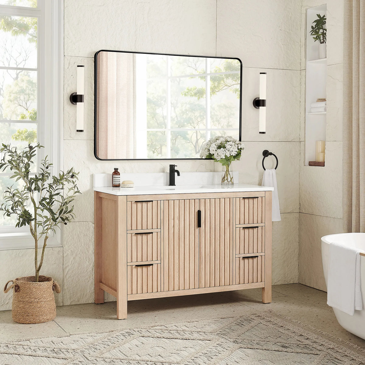 Second angle: 48-inch cabinet in Aged Natural Oak with a matching rectangular mirror in a black frame and a plant