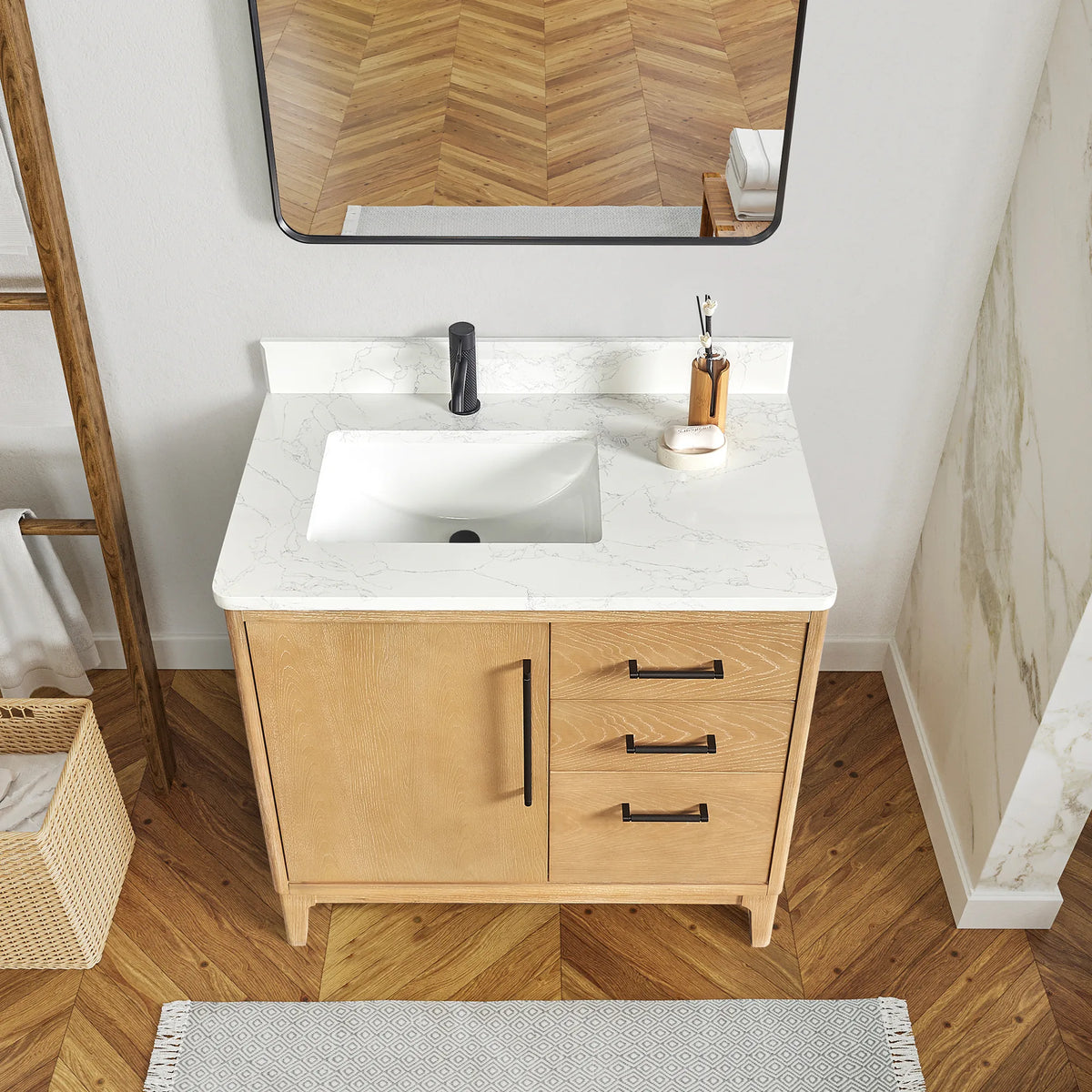 Near view of the Natural Wood front and White Grain composite stone top, a bath with herringbone flooring