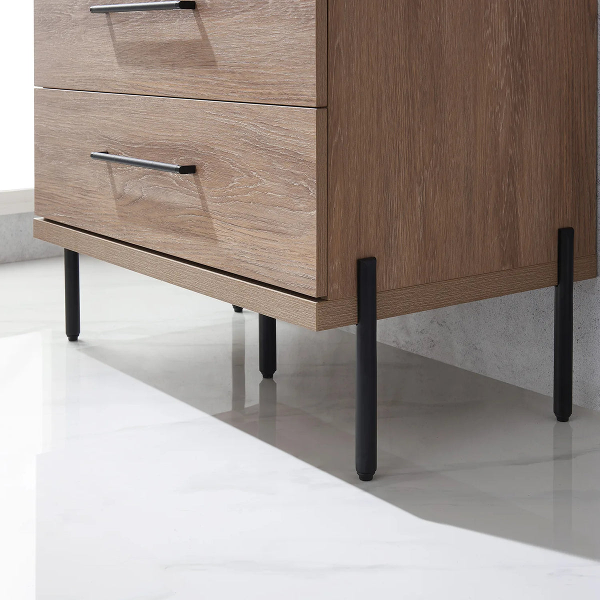 One of the slim black posts that holds up the cabinet, pale floor below