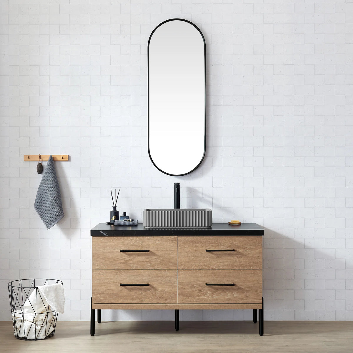 White brick-tile bathroom with the oval mirror and the oak vanity