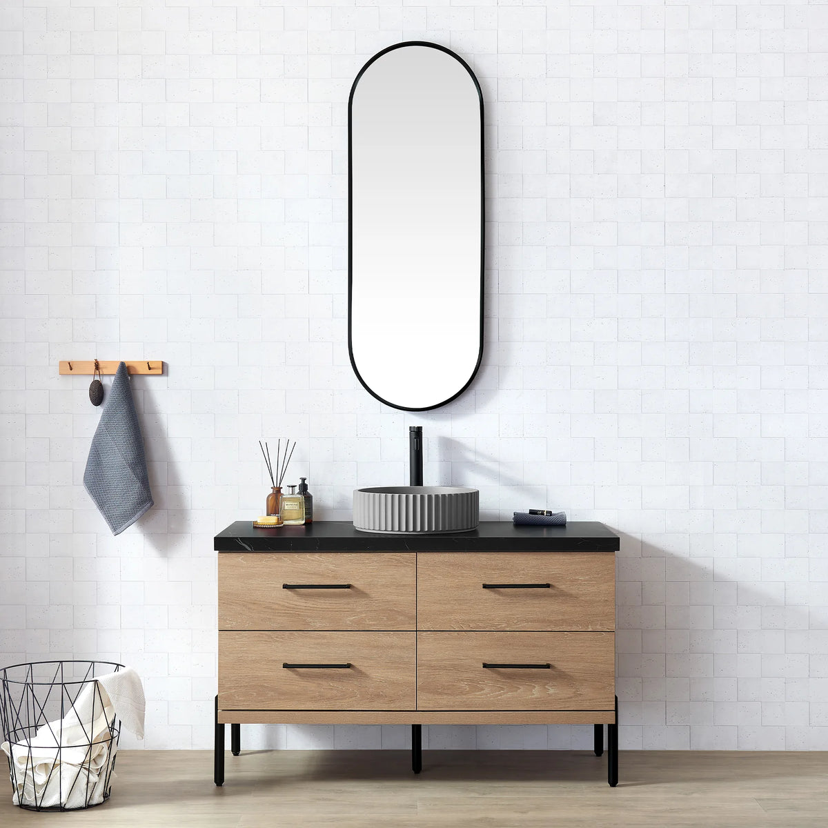 White brick-tile bathroom with the oval mirror and the oak vanity