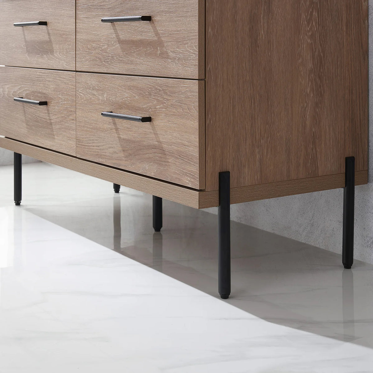 One of the slim black posts that holds up the cabinet, pale floor below