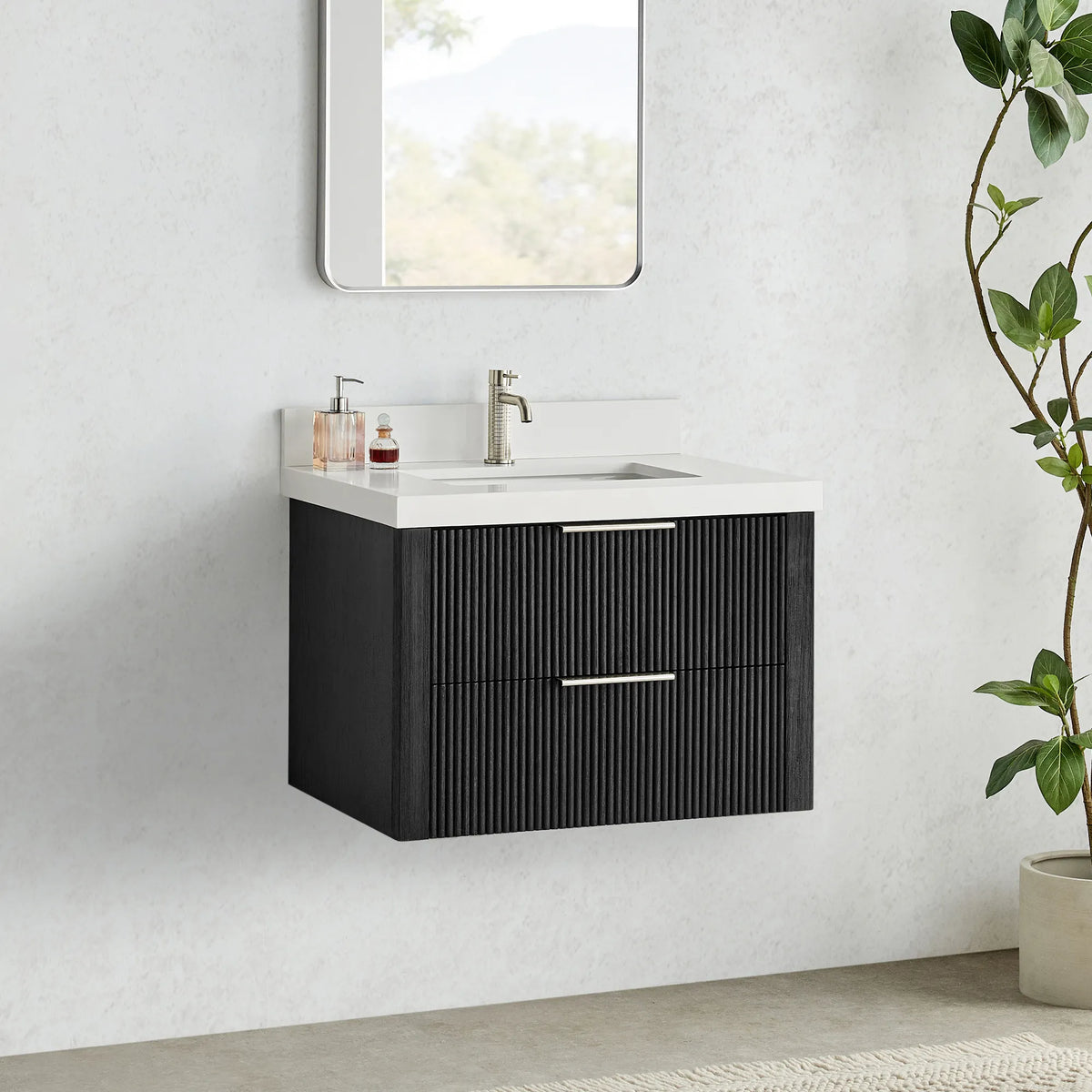 Oak Weathered Black floating vanity with sink and faucet, clear floor space below and a plant at right