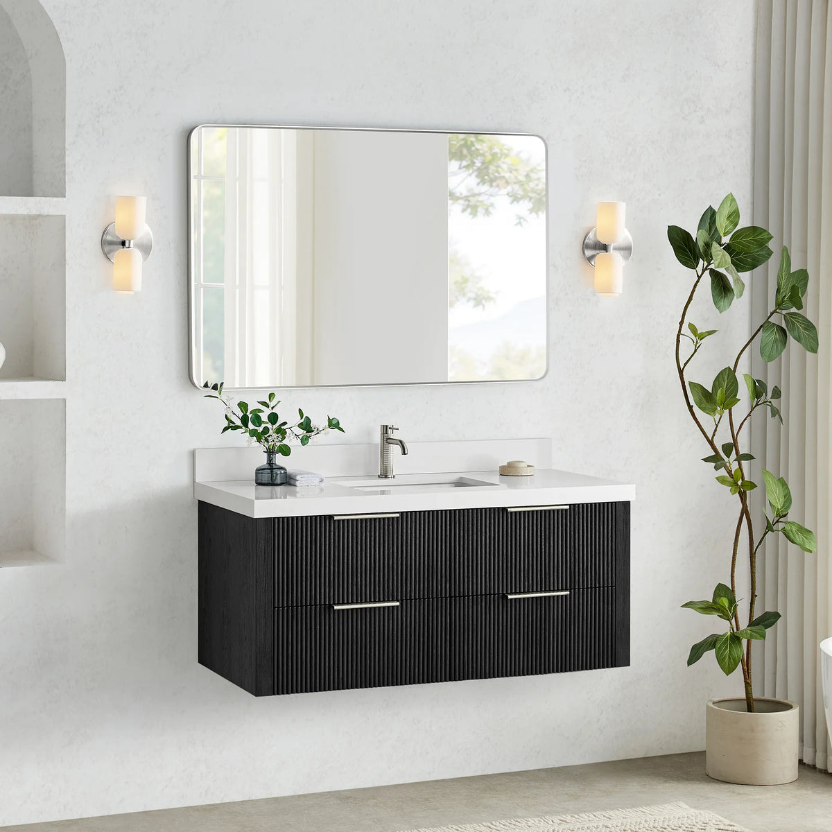 Oak Weathered Black floating vanity with sink and faucet, clear floor space below and a plant at right