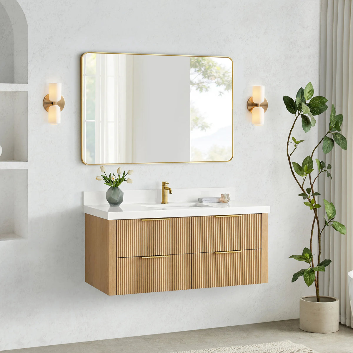 Washed Ash Grey floating vanity with sink and faucet, clear floor space below and a plant at right