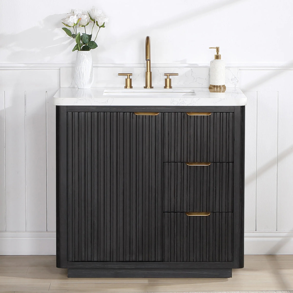 Freestanding 36 inch vanity in a white bathroom, flowers beside a widespread faucet and a soap dispenser