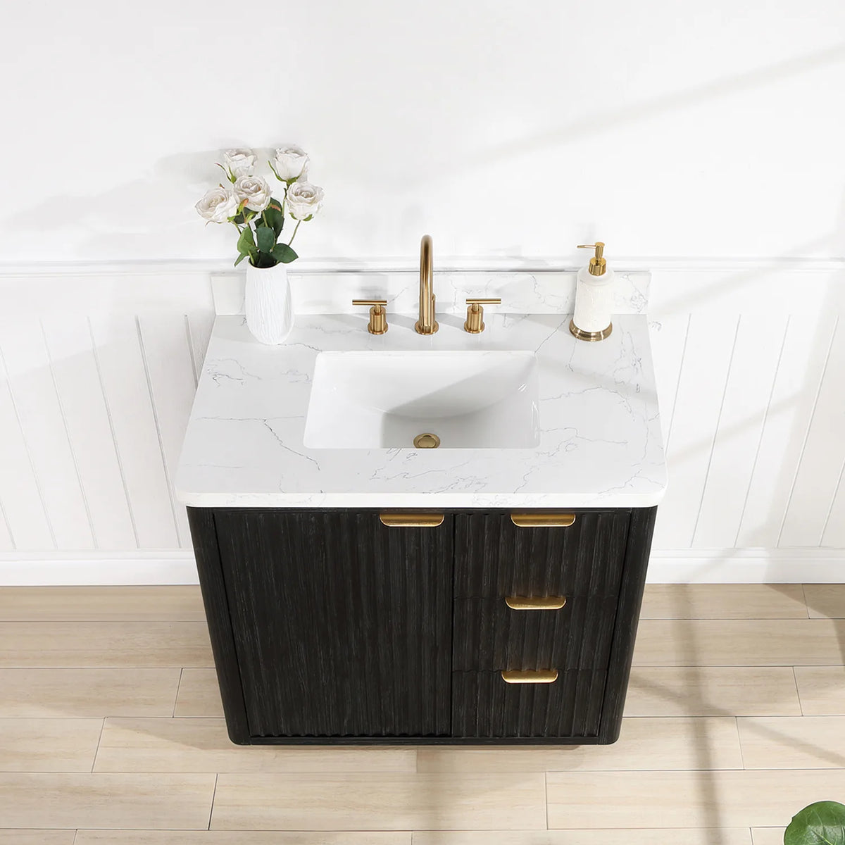 Close view of the 36 inch vanity top, undermount basin and flowers, with the door and drawers below
