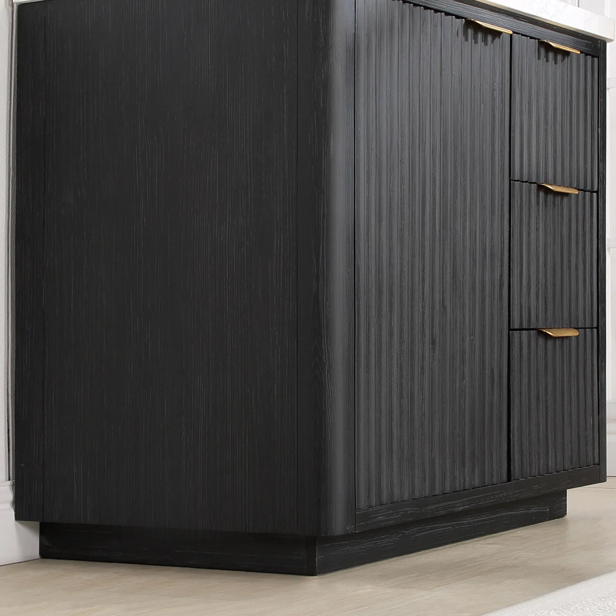 Corner view of the freestanding vanity body showing fluted side panel, plinth base and drawer fronts