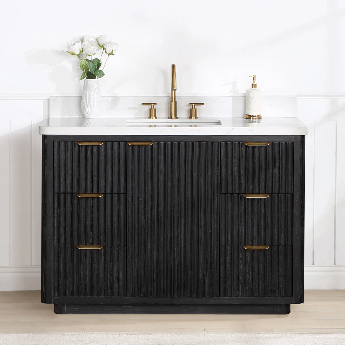 Freestanding 48 inch vanity in a white paneled bathroom with a displayed widespread faucet and soap dispenser
