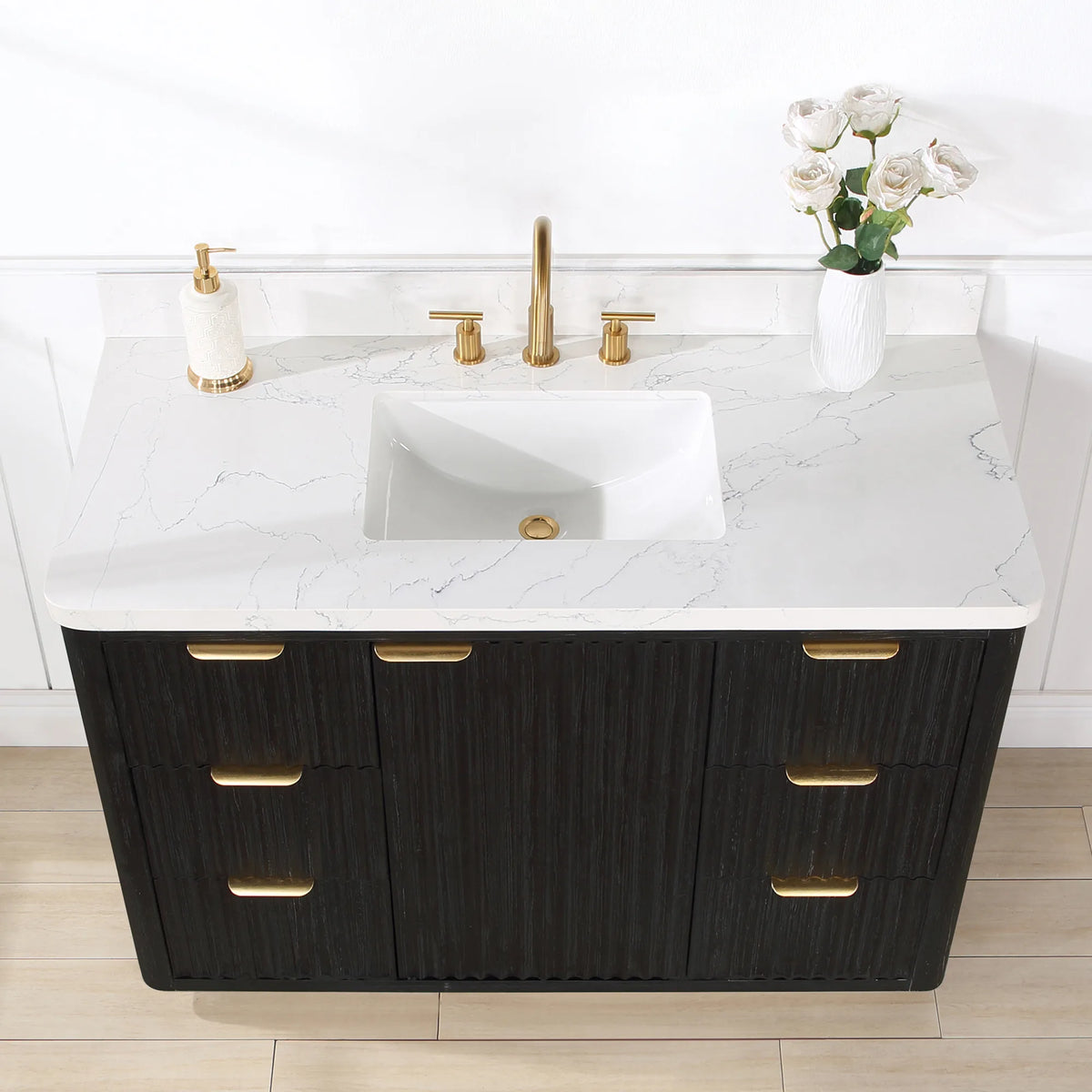 Close view of the 48 inch vanity top with undermount basin and a flower vase, drawer and door fronts below
