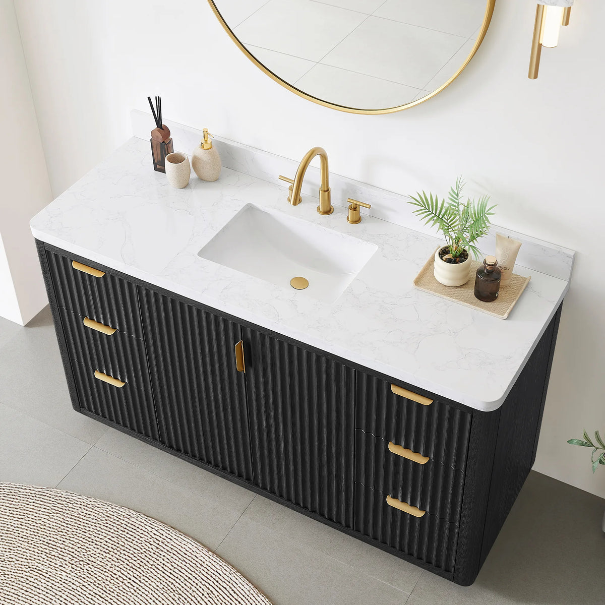 Close room view of the 60 inch vanity top with undermount sink, faucet, plant and diffuser, mirror above