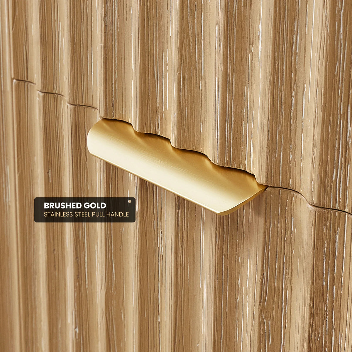 Close-up of the Brushed Gold pull handle in the vertically textured wood