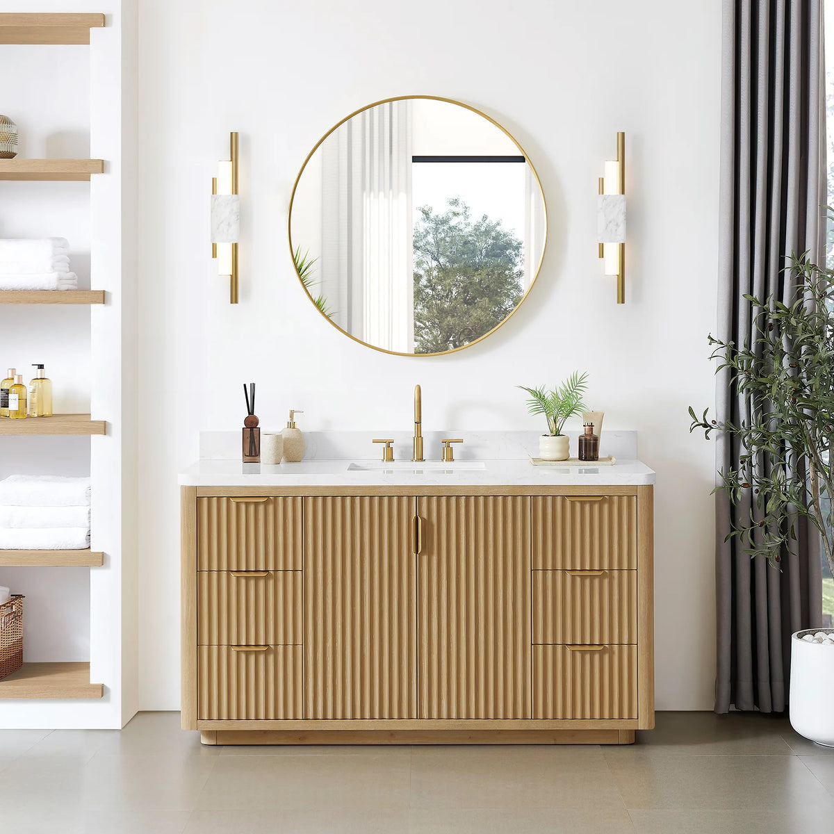 Room scene with the 60 inch Washed Ash Grey vanity, a circular mirror above and a plant at the right