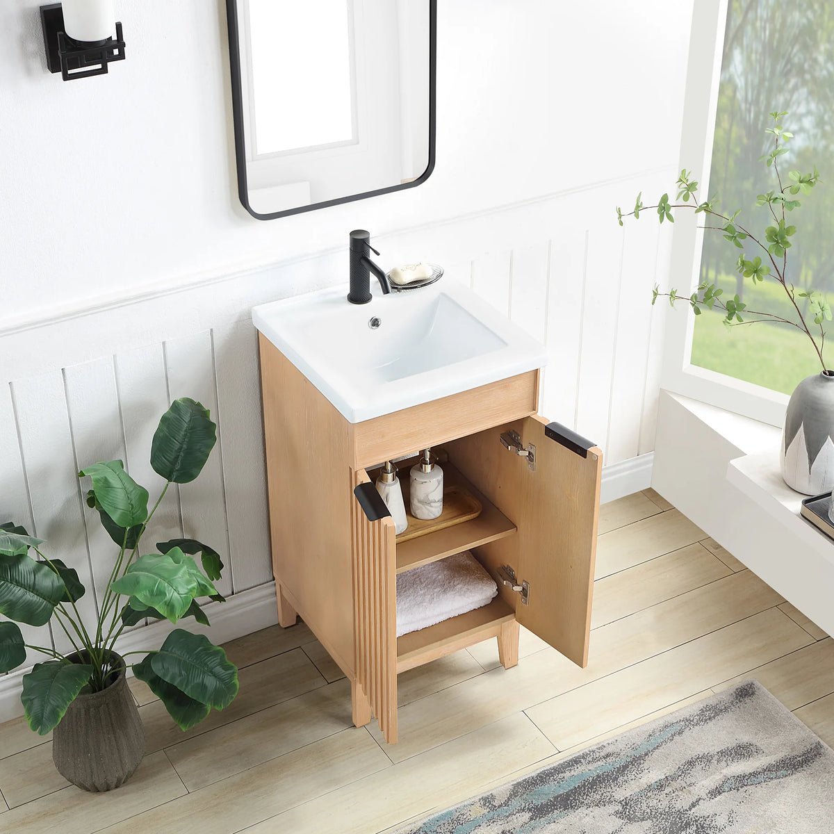 Doors swung open on the Fir Wood Brown vanity to show the storage inside; a bath with white paneled walls