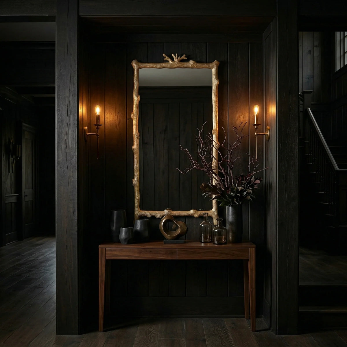 Ambella Home Twig wall mirror, 30W x 4D x 56H, featuring an organic branch motif frame above a walnut console in a dark luxury entry hall