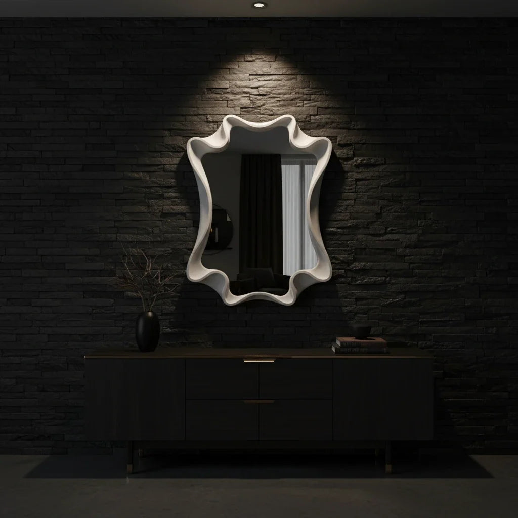 Decorative wall mirror on a dark brick wall with a black cabinet below.