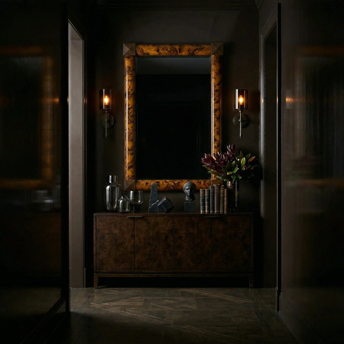 Ambella Home Delancy Mirror in tortoise shell finish, 38 by 56 inch rectangular wall mirror above a dark burl wood credenza in a moody luxury hallway