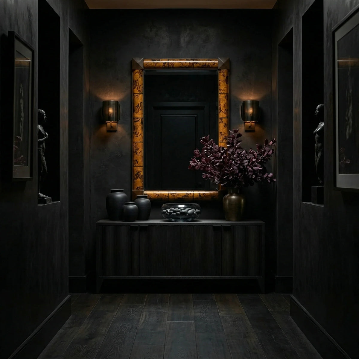 38 inch Delancy Mirror by Ambella Home with tortoise shell frame and dark corner detailing, styled above a black credenza in an elegant dark entry hall