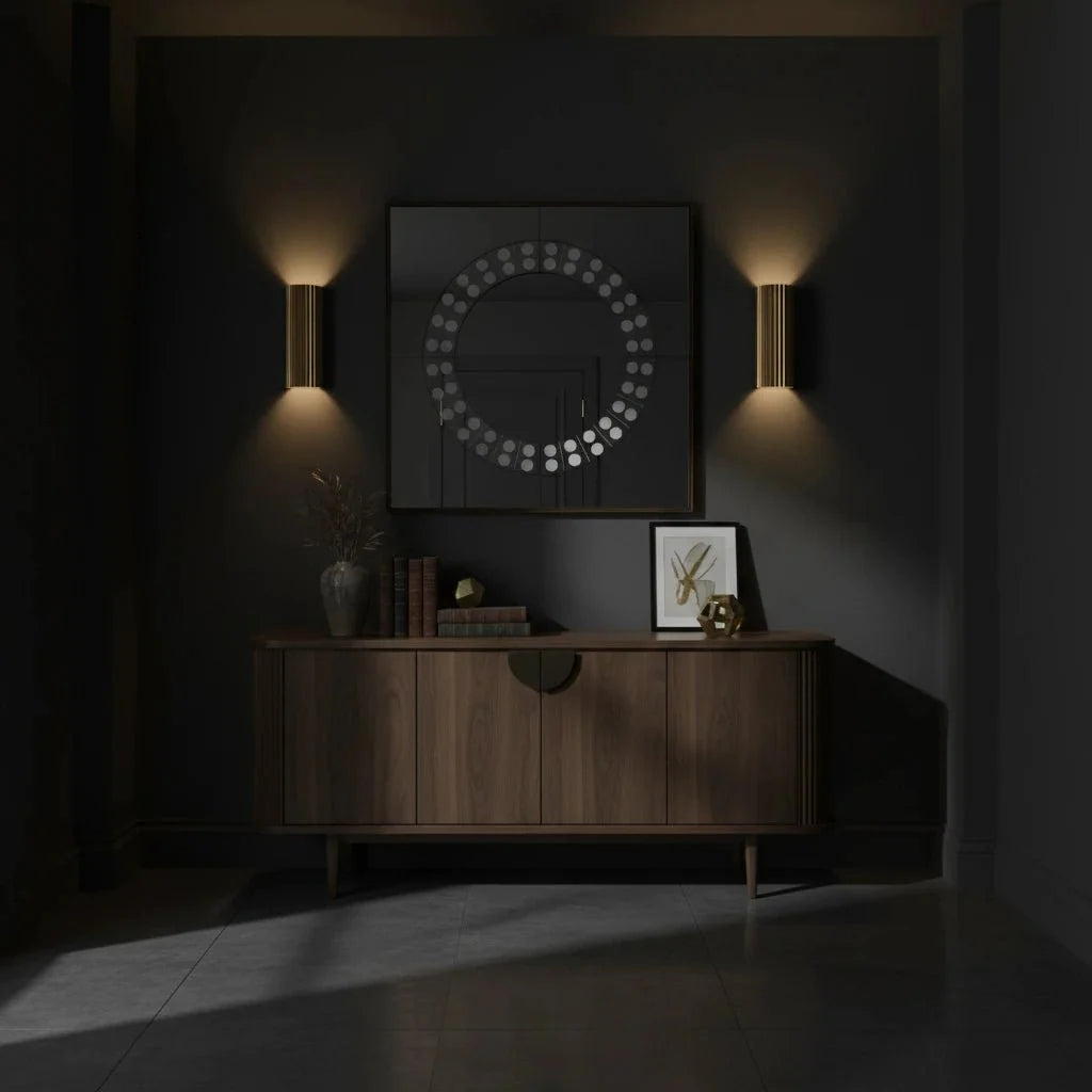 Dark room with wooden sideboard, framed picture, and wall lights.