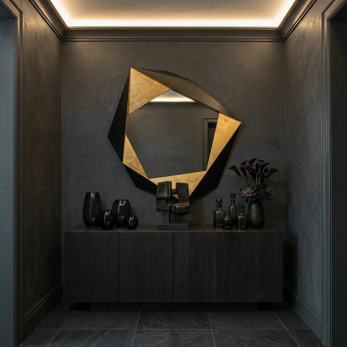 Ambella Home Folded geometric wall mirror, 48W x 5D x 49H, displayed above a dark credenza in a luxury interior hallway with sculptural decor