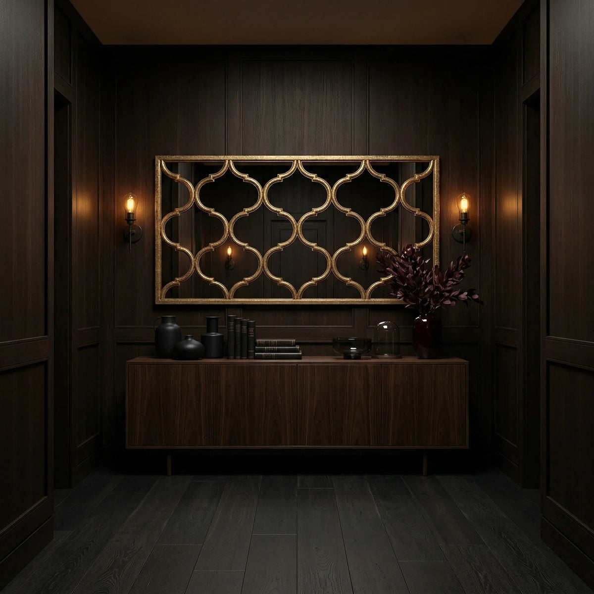 Horizontal Fret Mirror by Ambella Home in antique wire brush gold, oversized decorative wall mirror with repeating open fret motif above a walnut credenza in a dark luxury hall