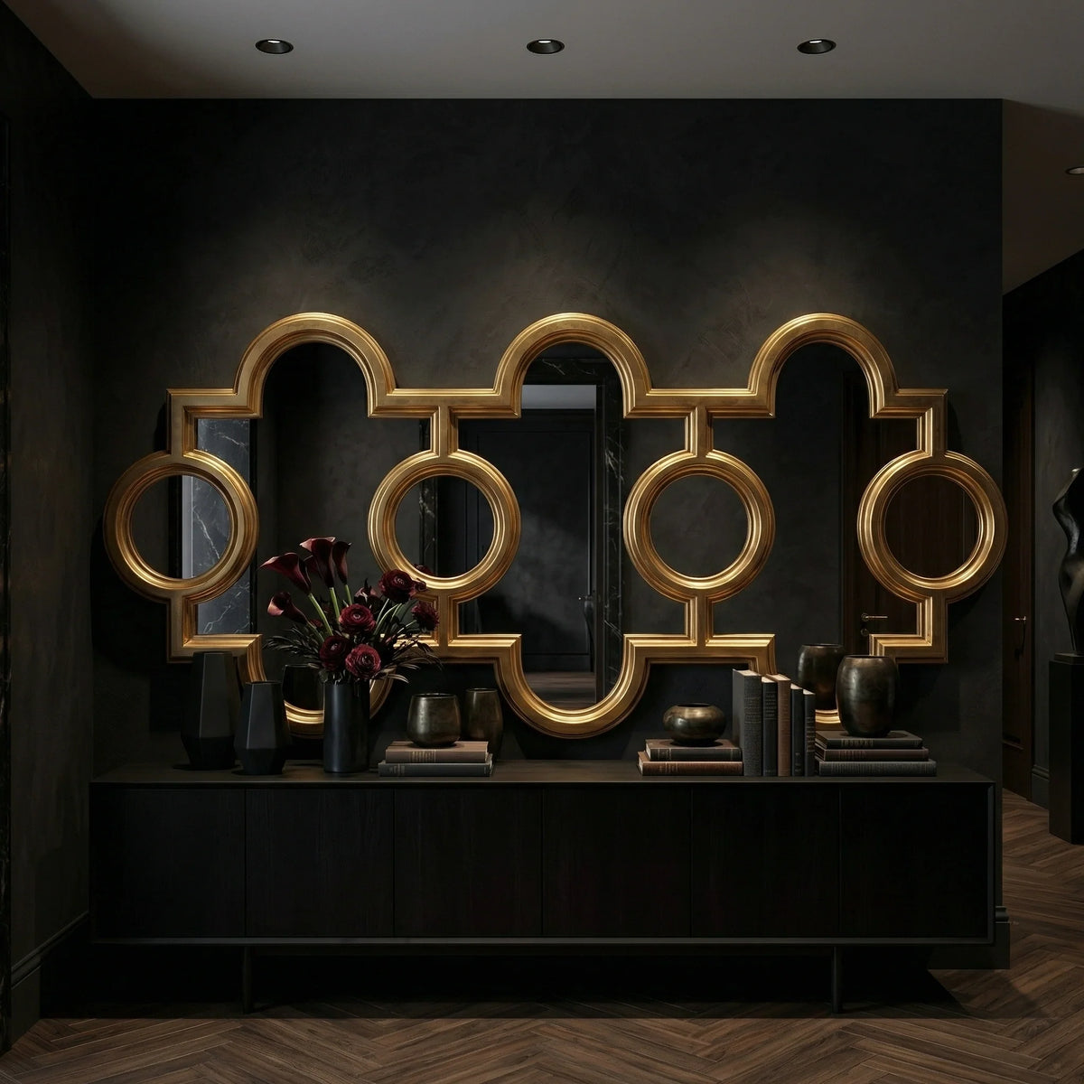 Ambella Home Voranado Mirror in burnished gold leaf, 99W x 3D x 43H oversized sculptural wall mirror with circular and arched geometric frame above a dark credenza in a luxury hallway